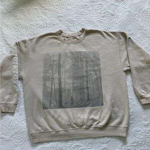 Taylor Swift Folklore Tan Crewneck Sweater with Taylor in a forest